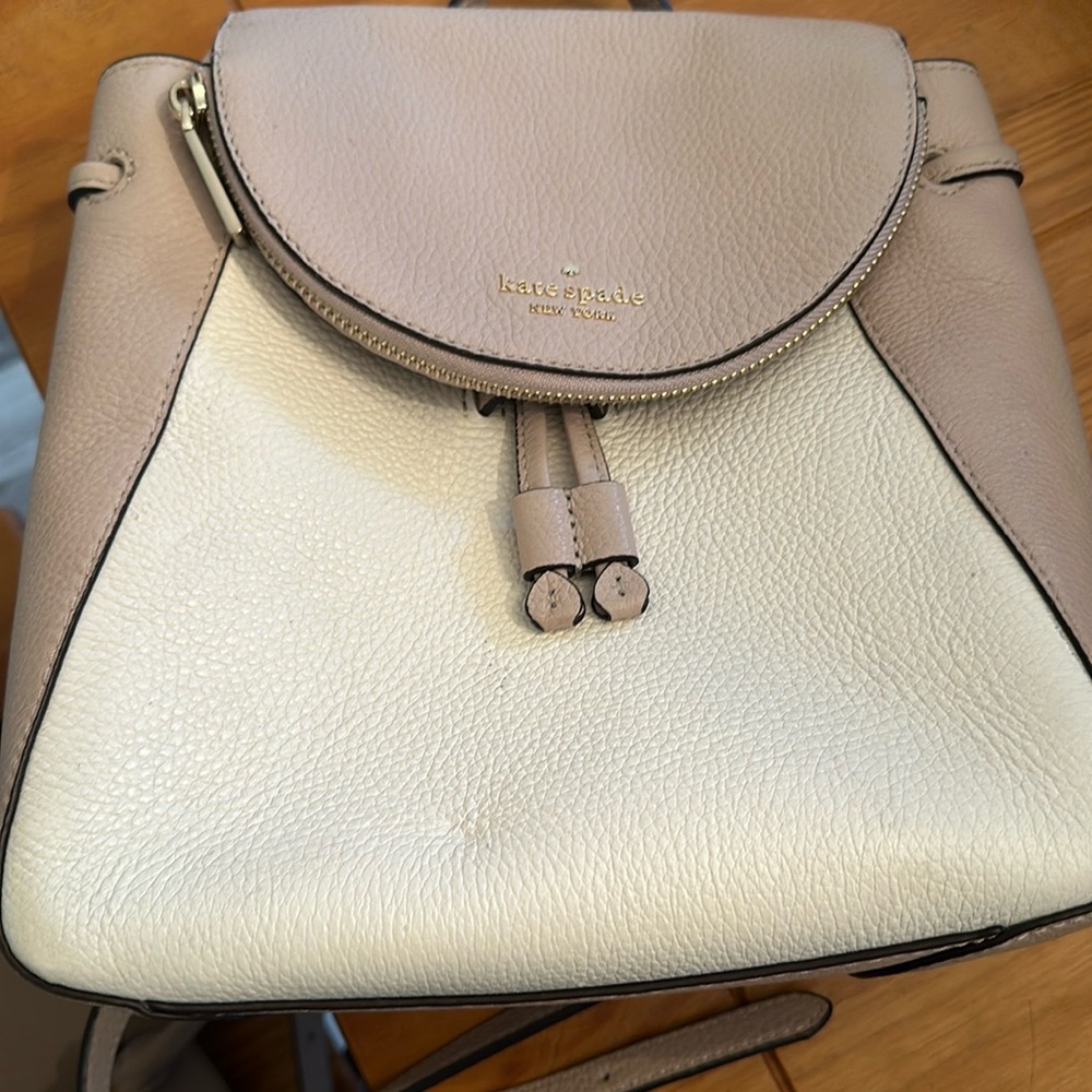Kate Spade backpack nude and cream colored. Small marks on the outside of purse.